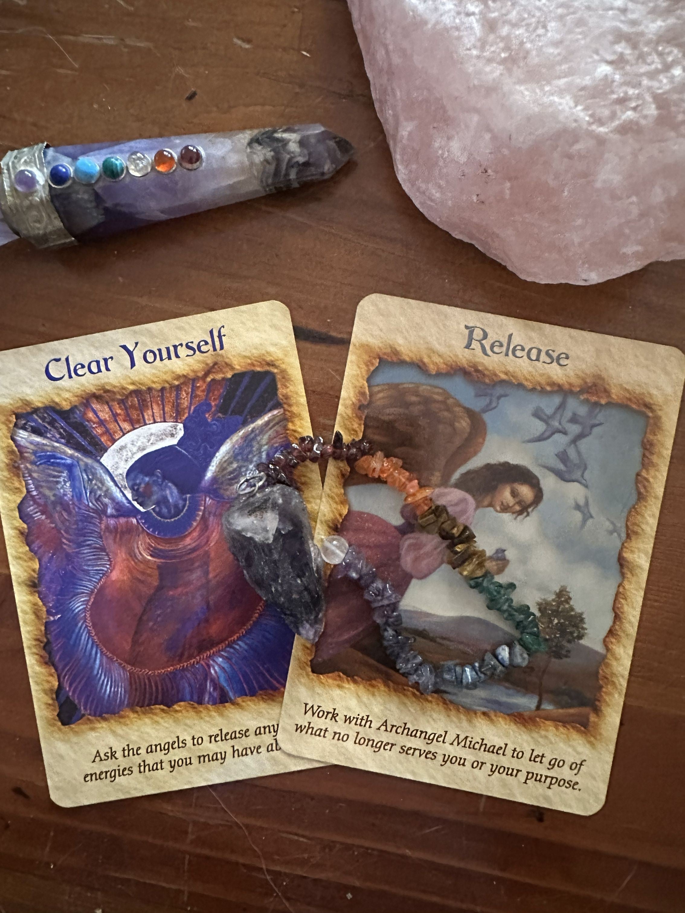 Two tarot cards and a pendulum arranged for a quick mapped insight reading