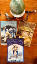 Three tarot cards and a pendulum , with a crystal power sphere laid out for depper intuitive guidance