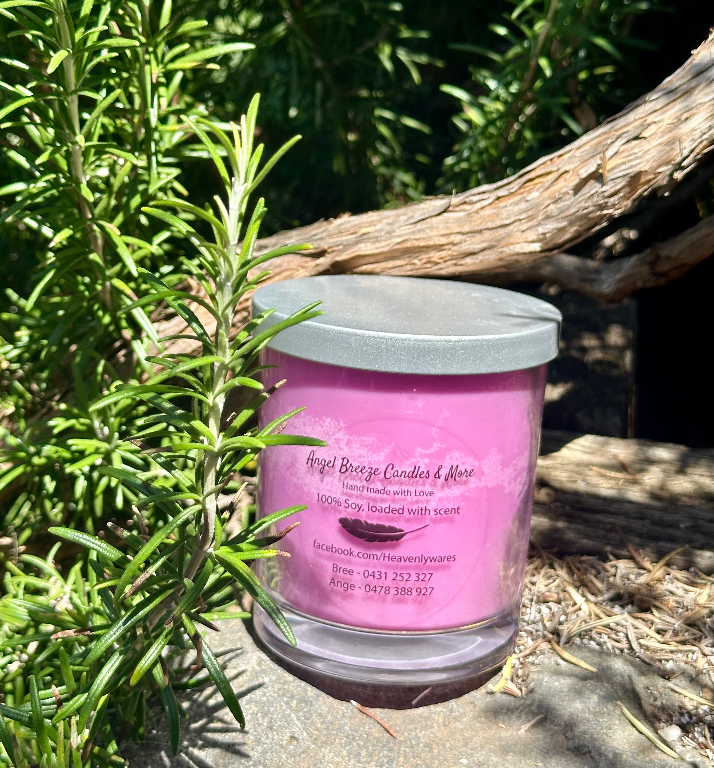 Black Raspberry vegan soy candle nestled in rosemary bush