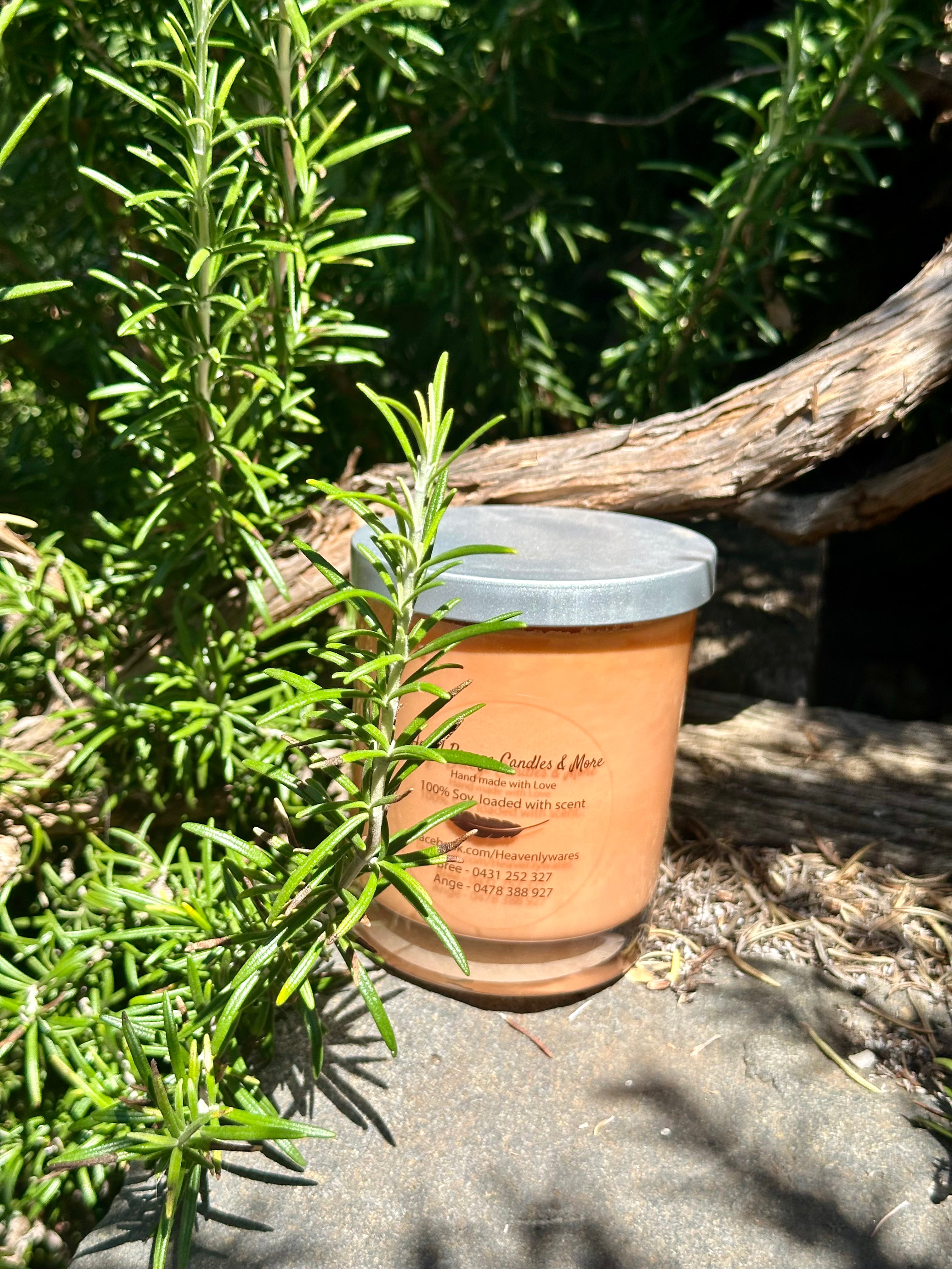 By the fire vegan soy candle nestled in rosemary bush