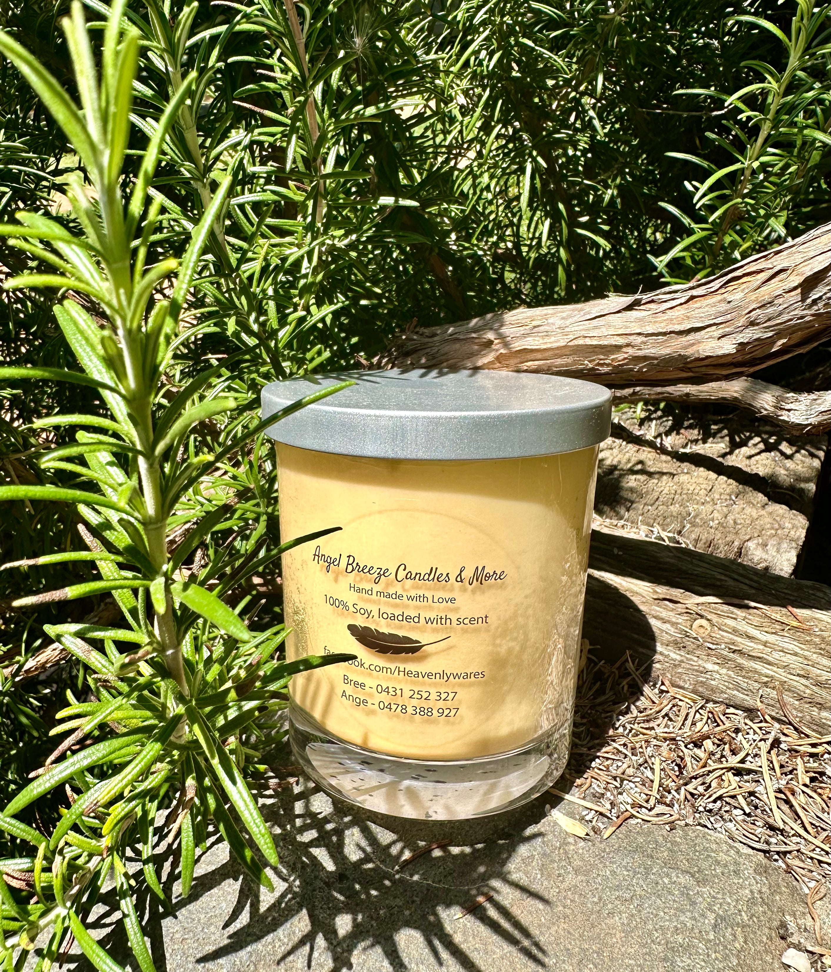 Classic floral (No. 5 inspired) vegan soy candle nestled in rosemary bush