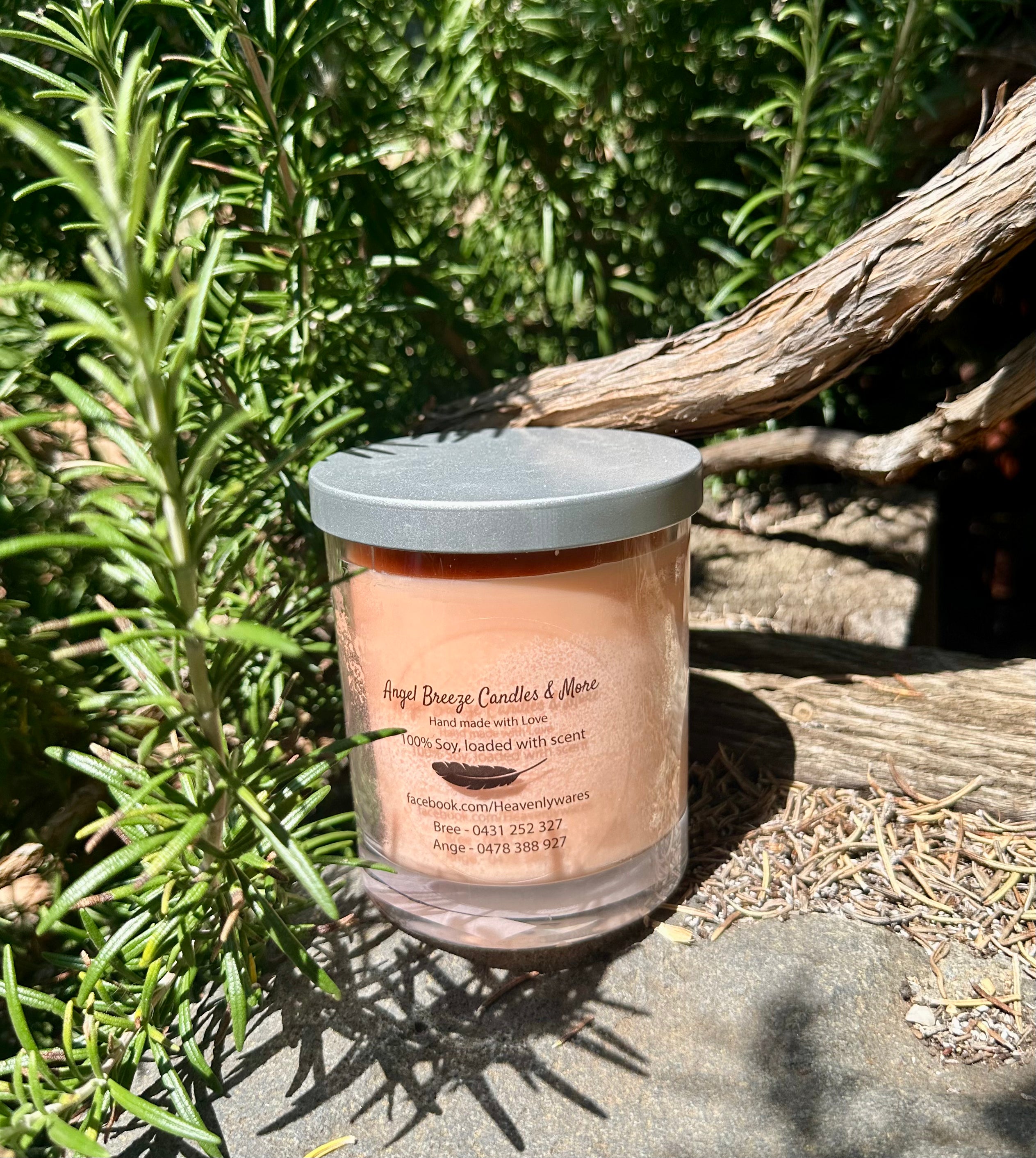 Cheeky Monkey vegan soy candle nestled in rosemary bush