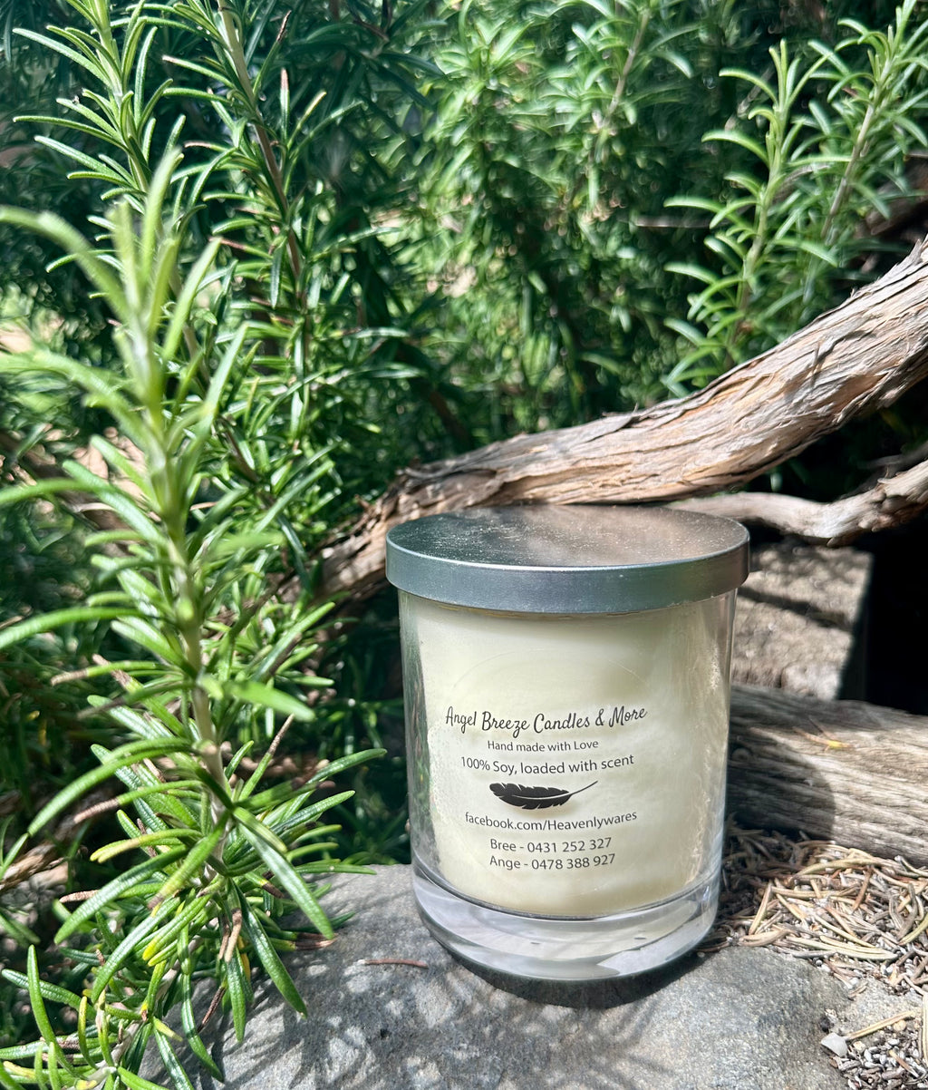 Citrus and Sage vegan soy candle nestled in rosemary bush