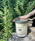 Citrus and Sage vegan soy candle nestled in rosemary bush