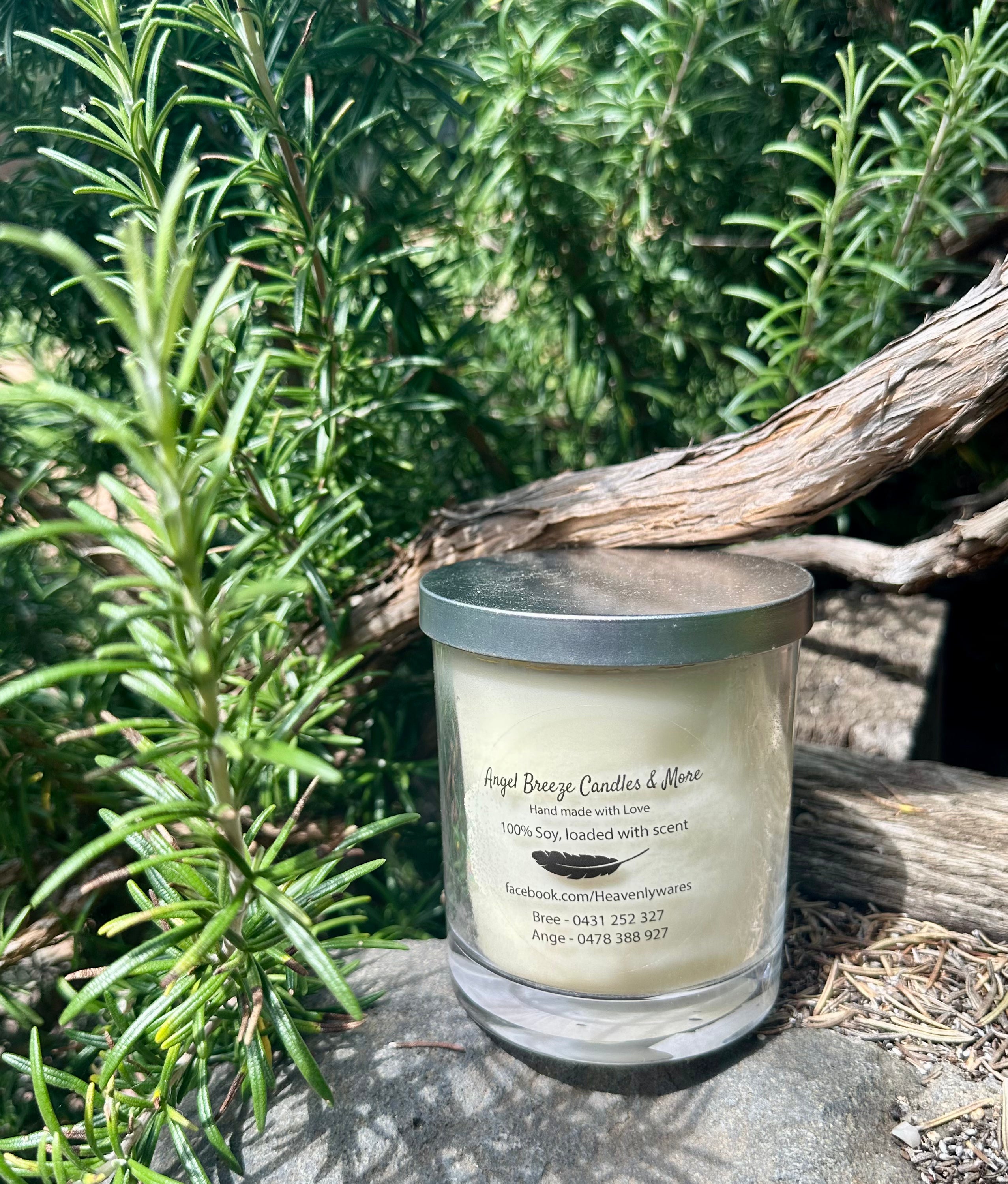 Citronella vegan soy candle nestled in rosemary bush