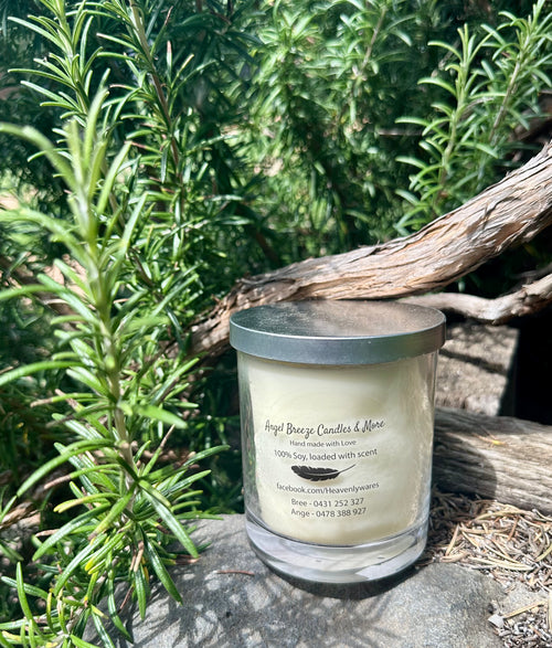 Citronella vegan soy candle nestled in rosemary bush