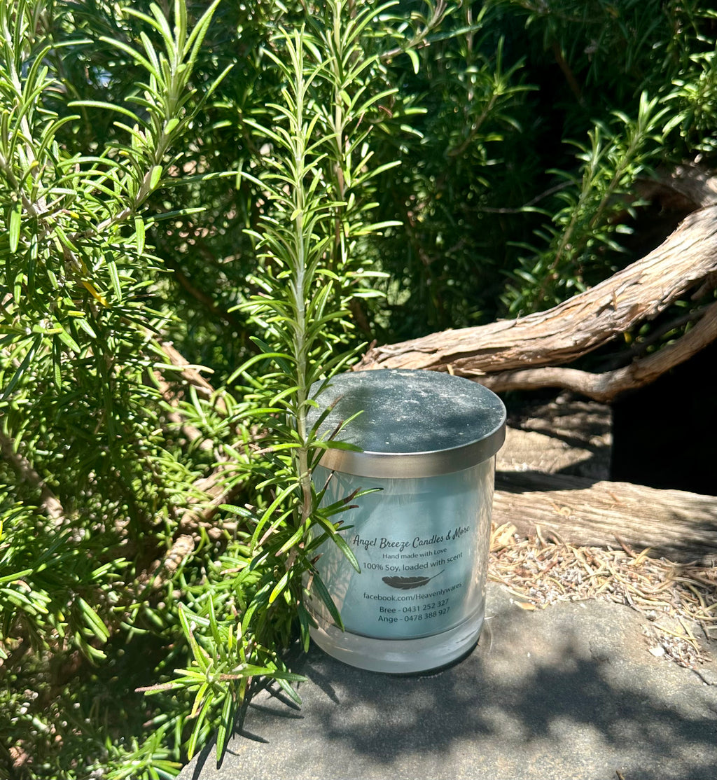 Lily of the Valley vegan soy candle nestled in rosemary bush