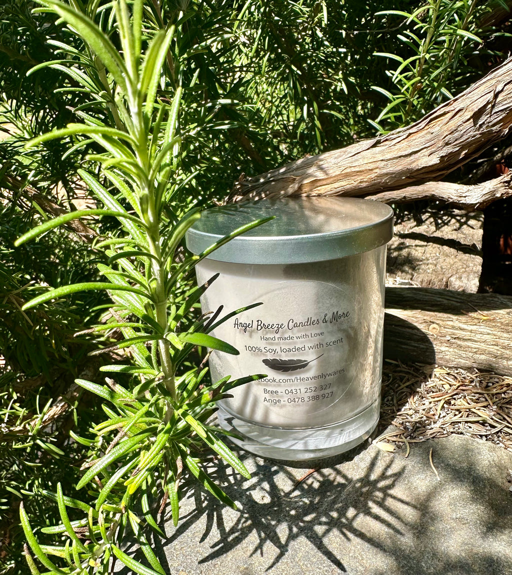 Little Black Dress vegan soy candle nestled in rosemary bush