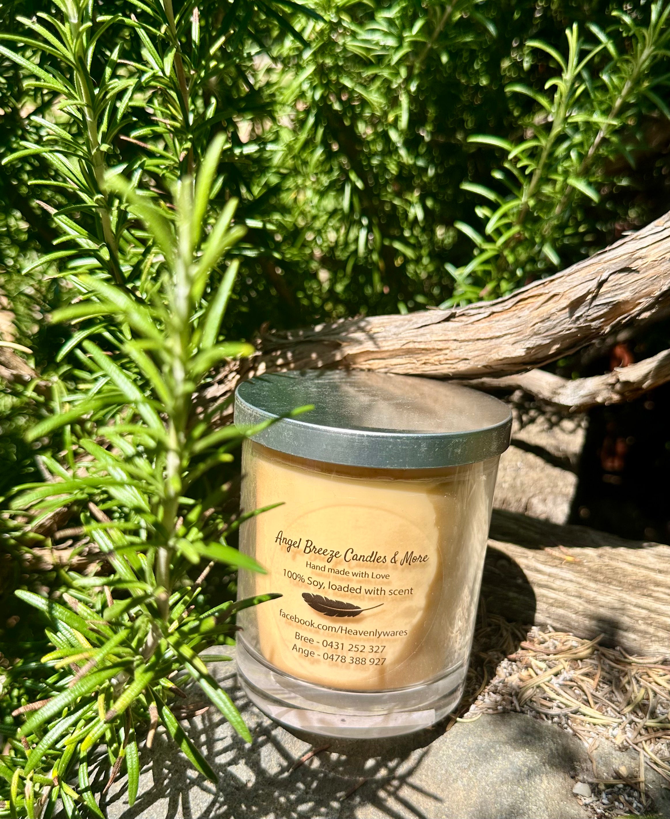Embers vegan soy candle nestled in rosemary bush