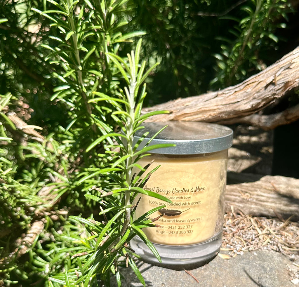 Sandalwood vegan soy candle nestled in rosemary bush