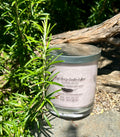 Sensual Musk tripled scented vegan soy candle nestled in rosemary bush