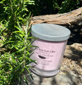 Smoked Amber & Sensual Musk tripled scented vegan soy candle nestled in rosemary bush