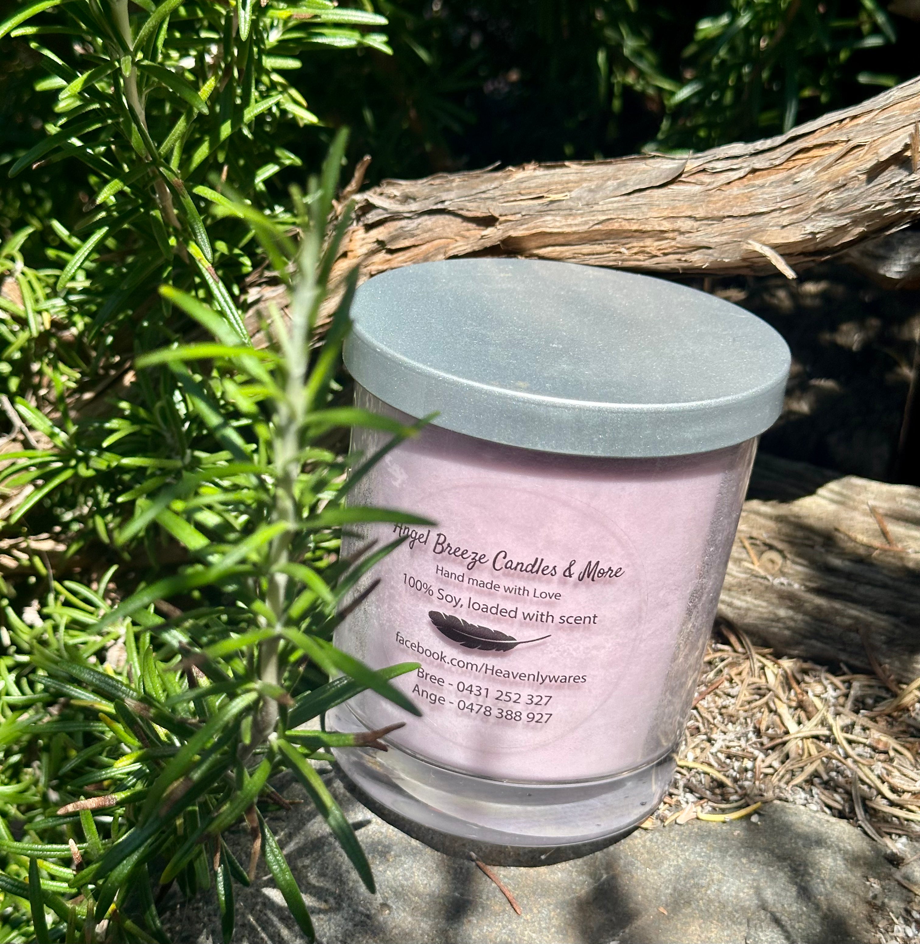 Smoked Amber & Sensual Musk tripled scented vegan soy candle nestled in rosemary bush