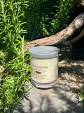 Tahitian Vanilla vegan soy candle nestled in rosemary bush