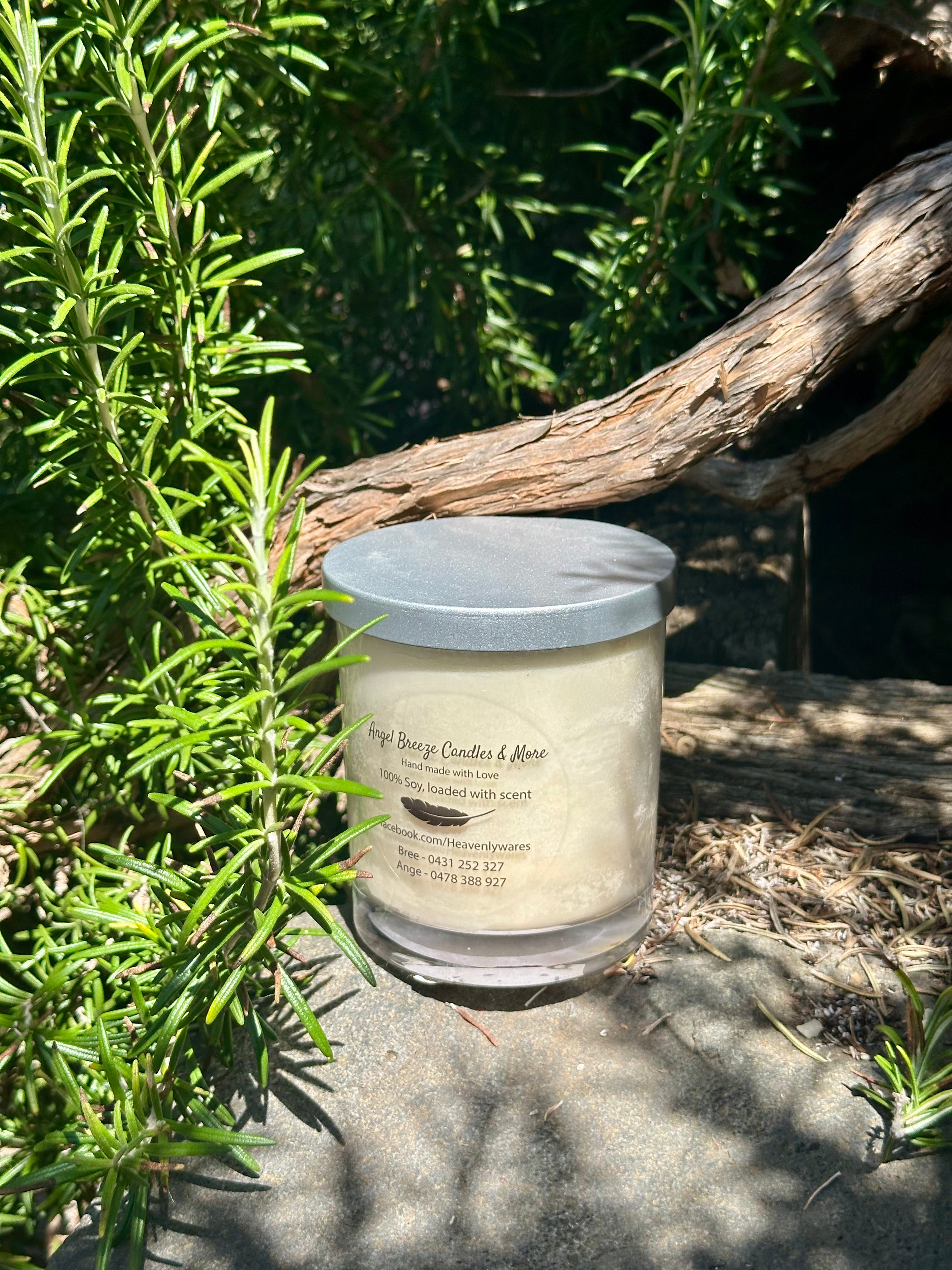 Tahitian Vanilla vegan soy candle nestled in rosemary bush