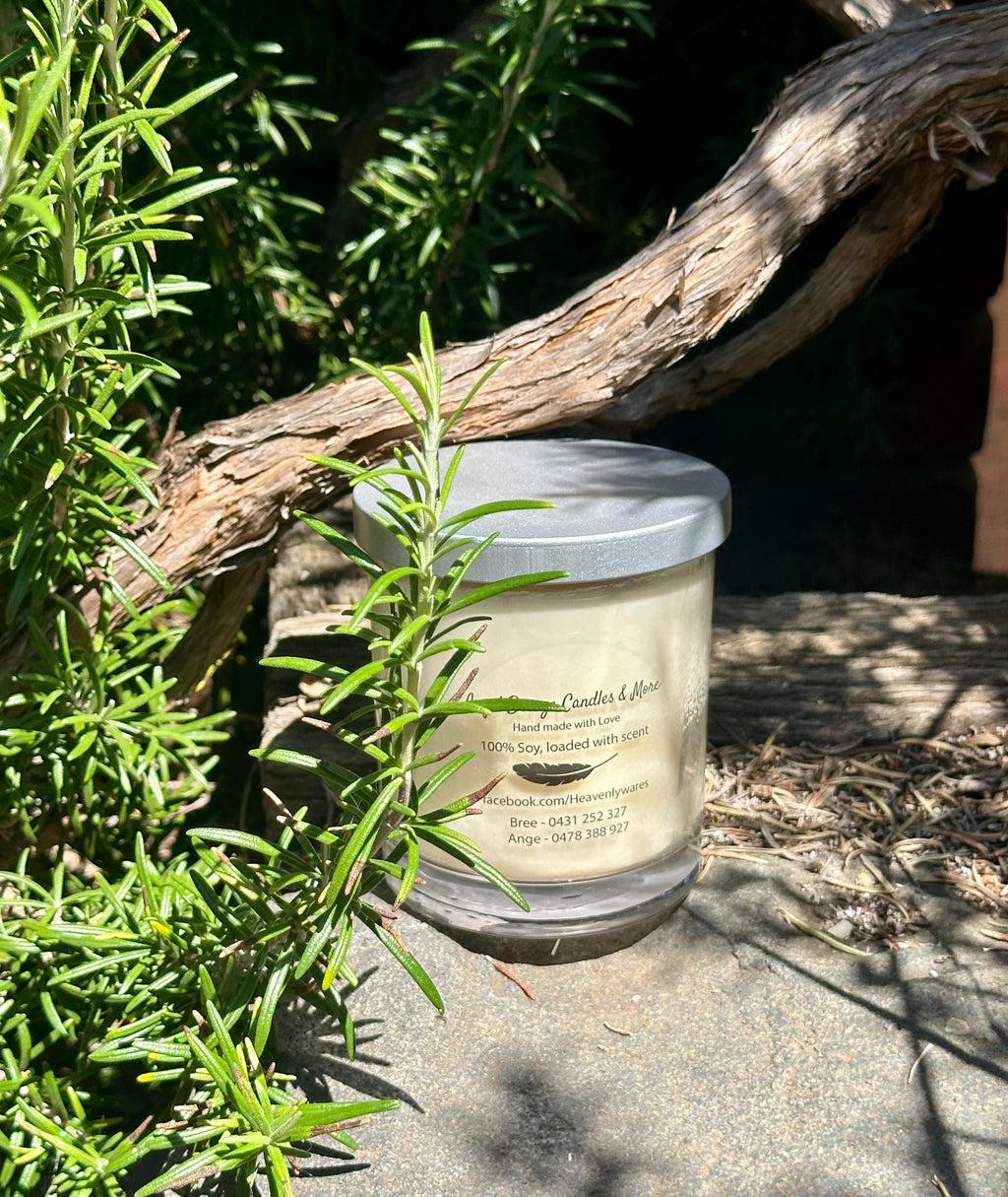 Vegan soy candle nestled in rosemary bush