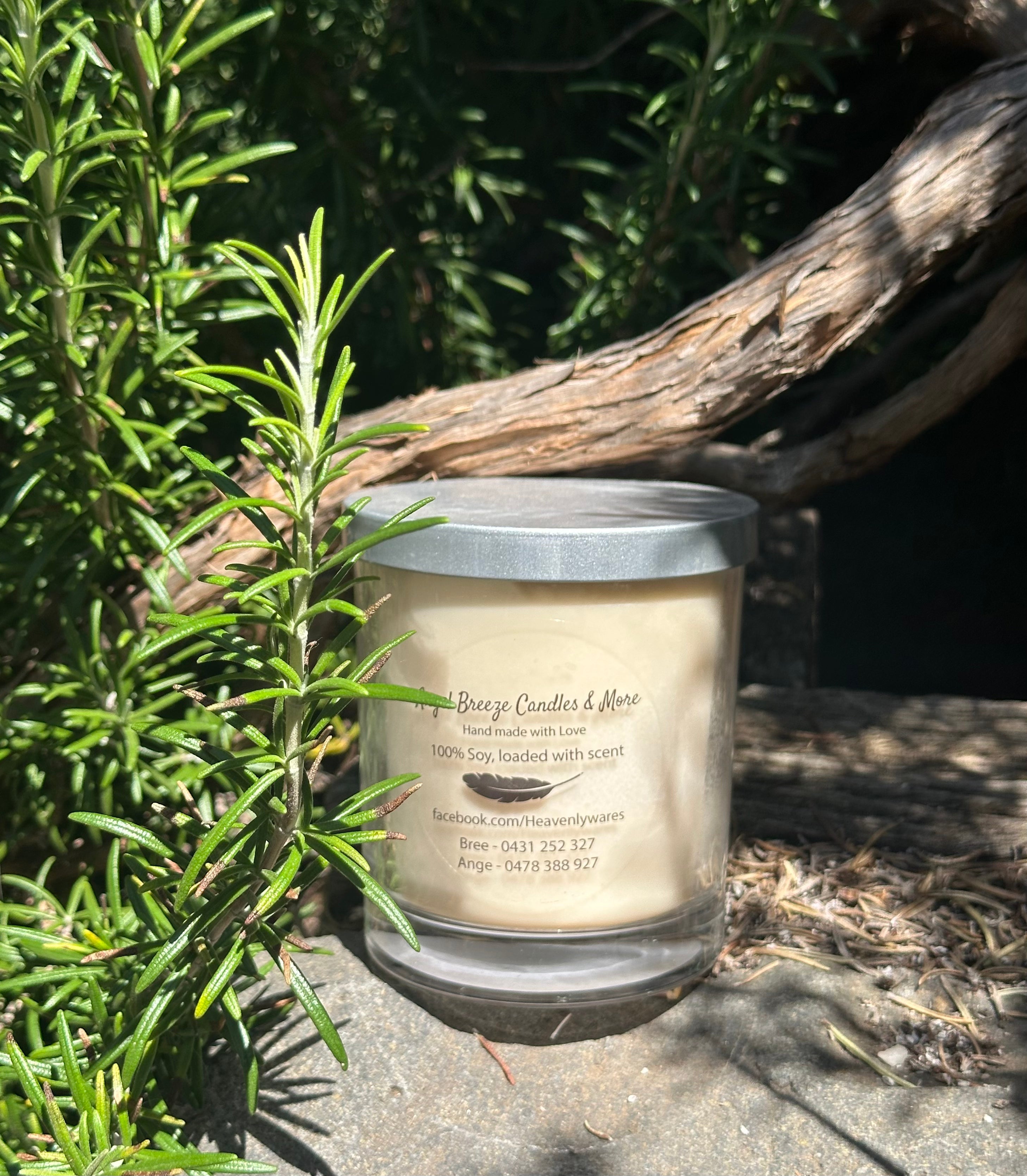 Ylang Vanilla vegan soy candle nestled in rosemary bush